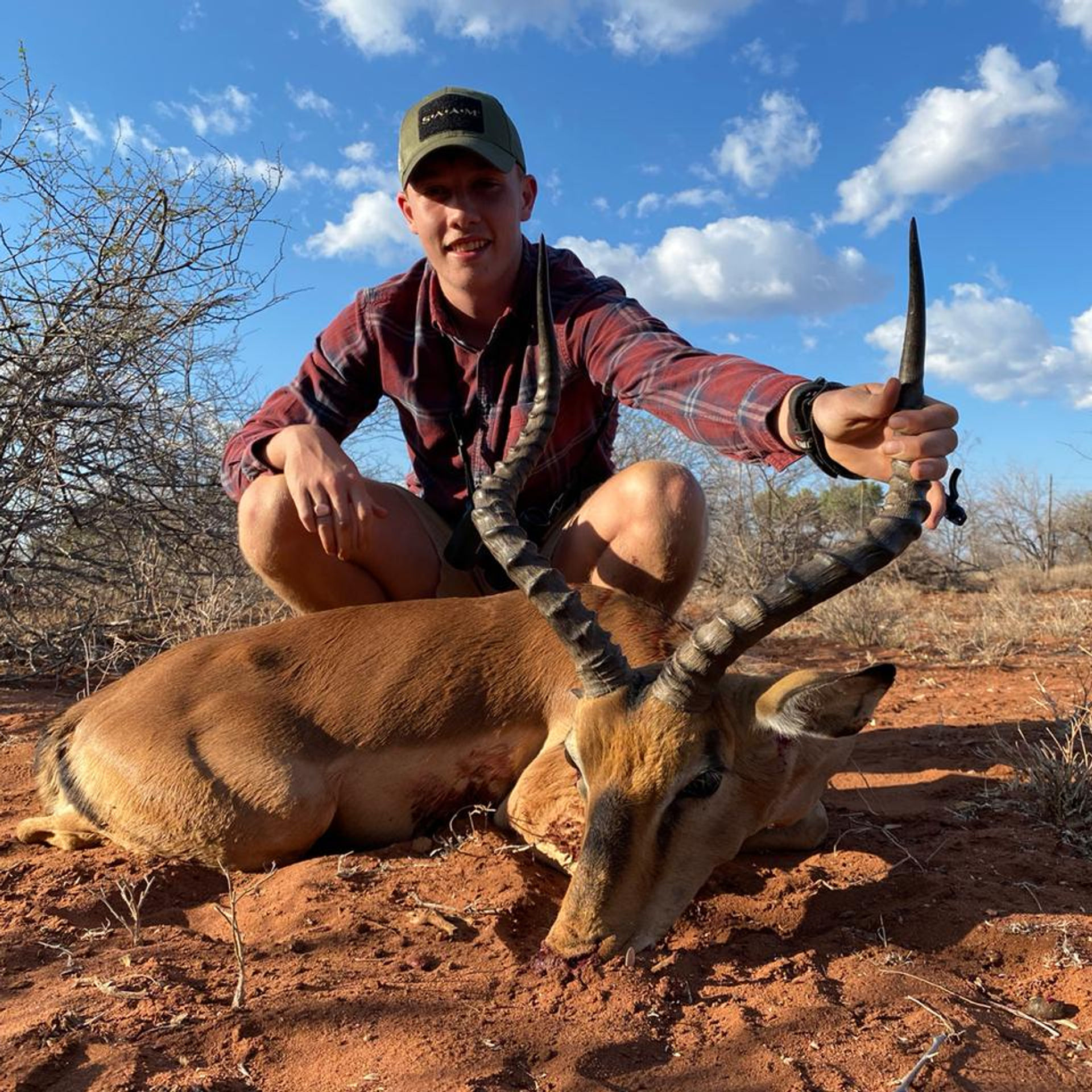 Young hunter with an impala trophy