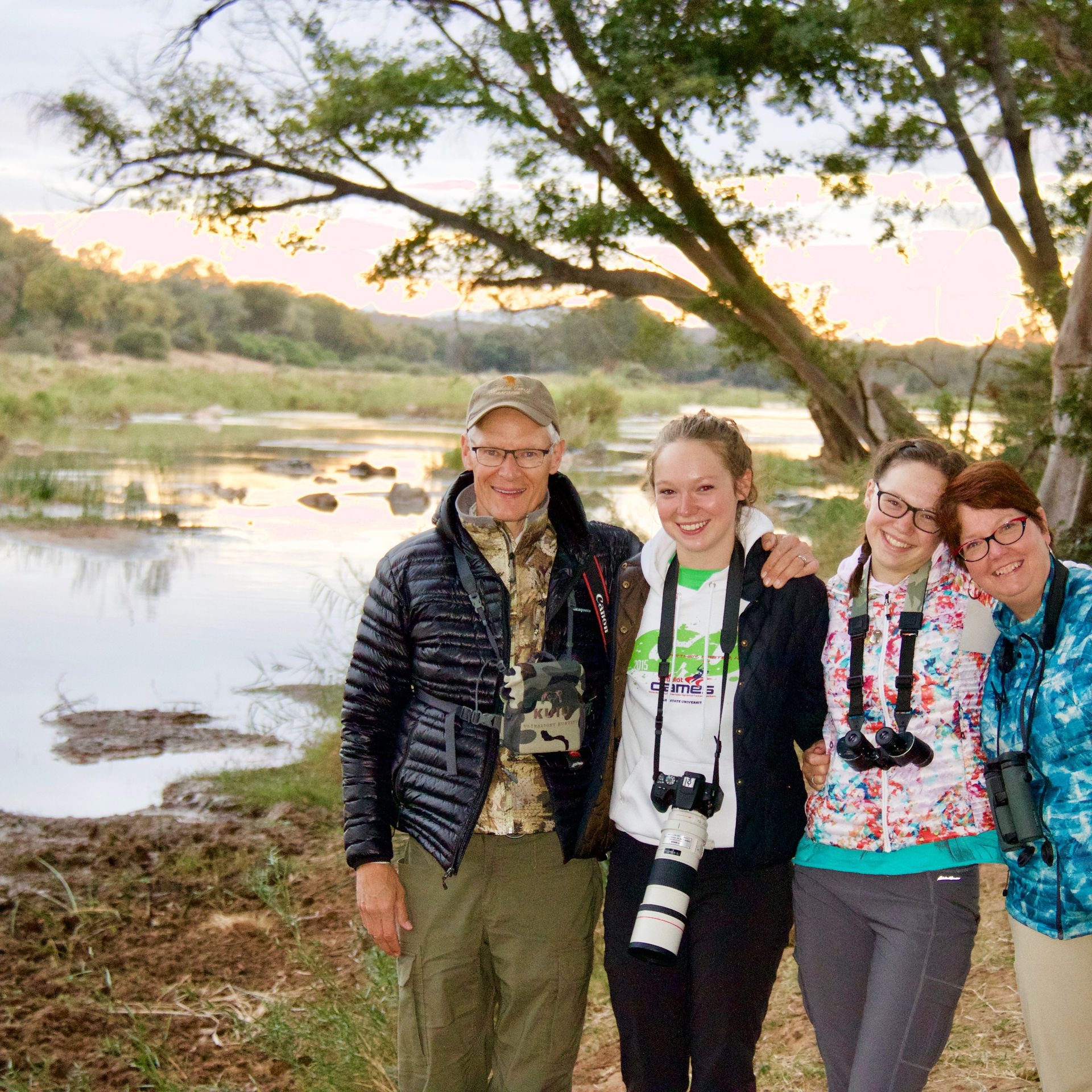 Family at sunset by a hippo pool